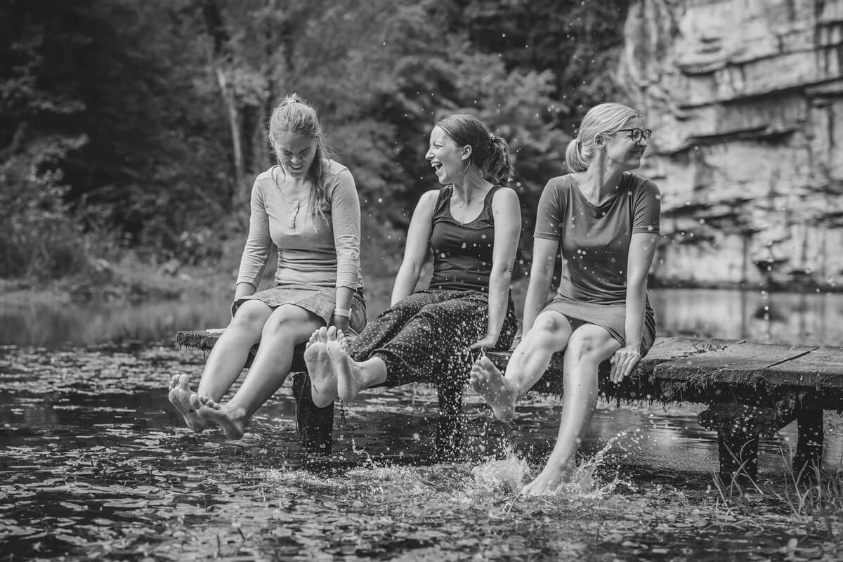 Three ladies with their feet in the water
